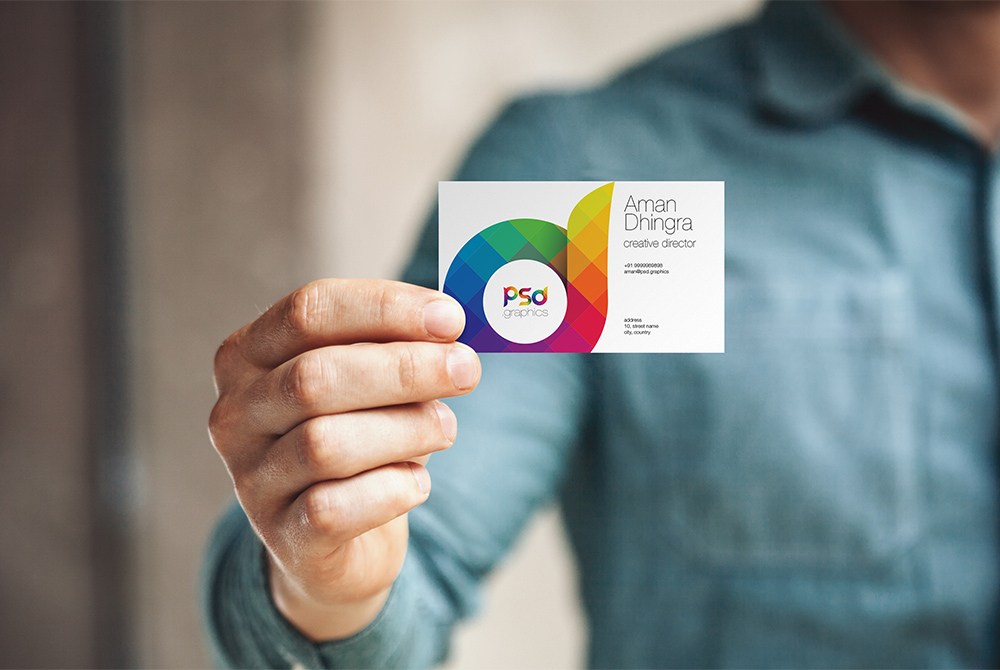 Free man holding business card mockup