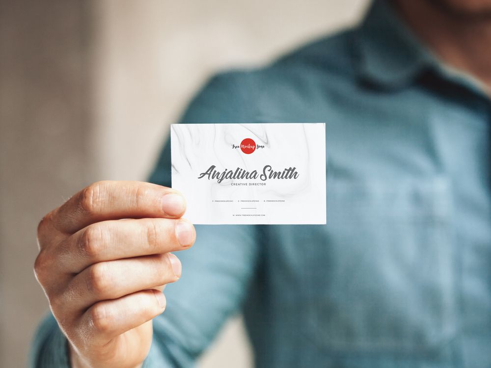 Free man holding in hand a business card mockup