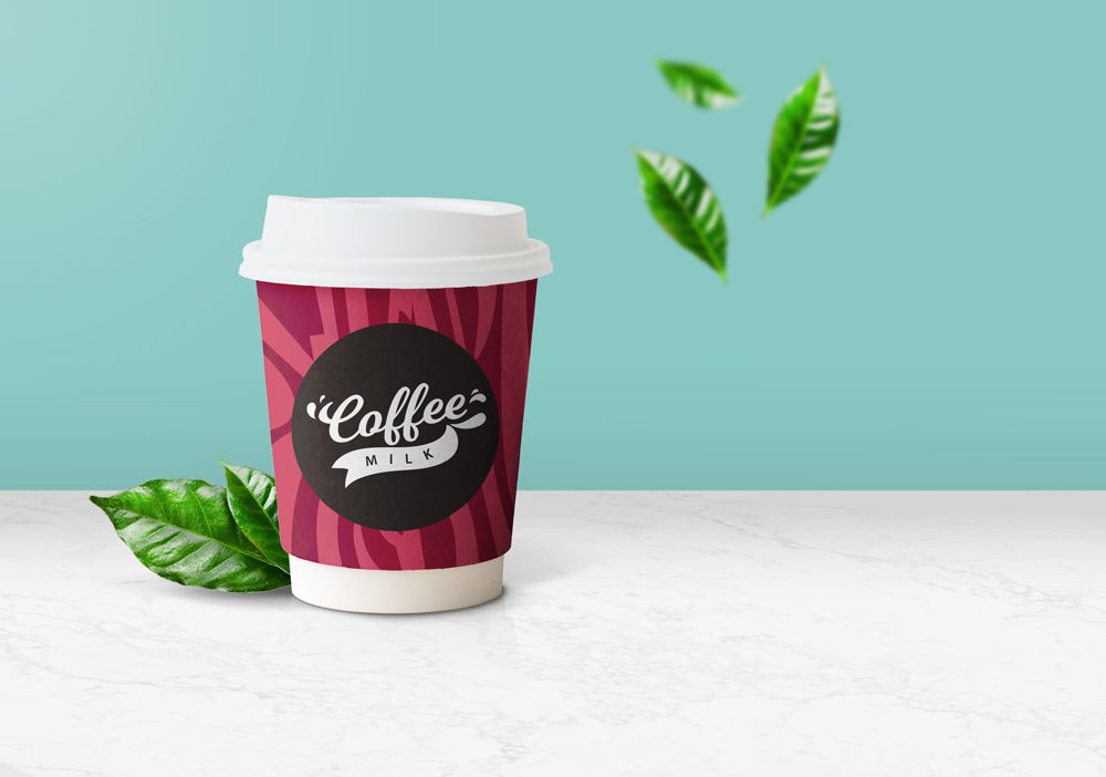 Free coffee cup mockup with green leafs