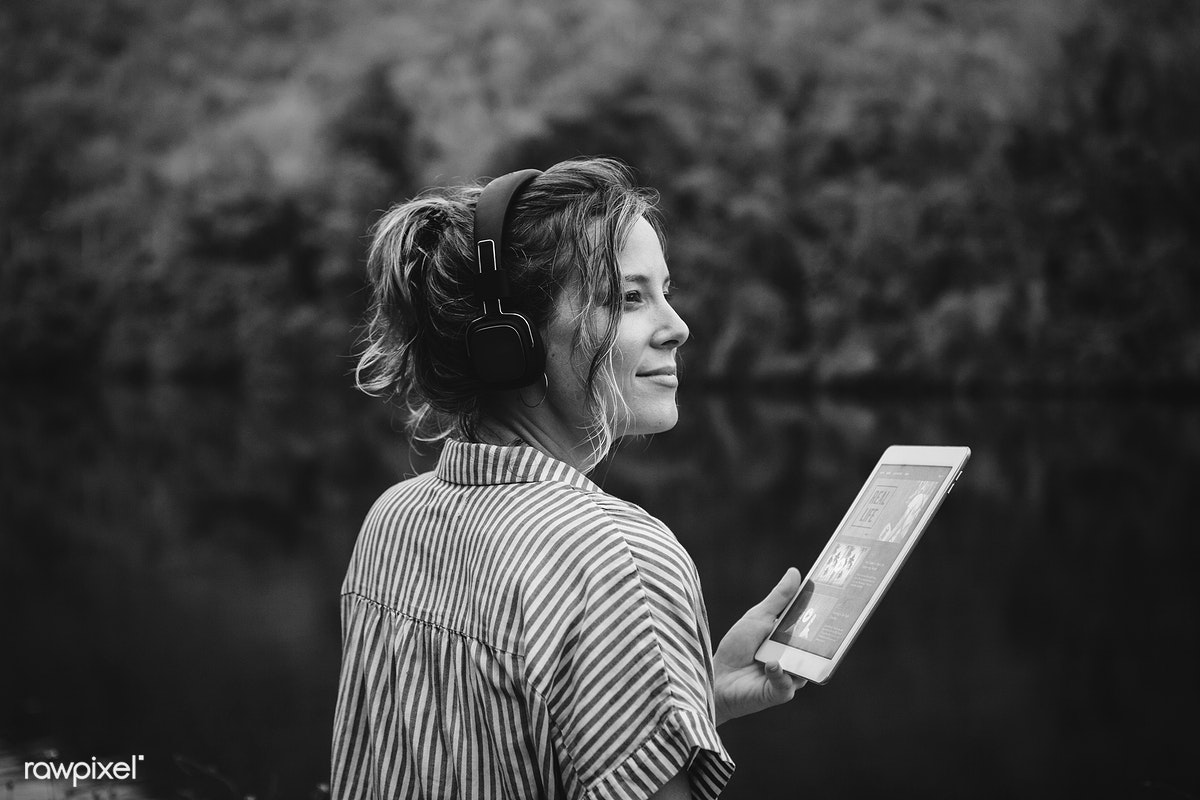 A black and white women watching ipad