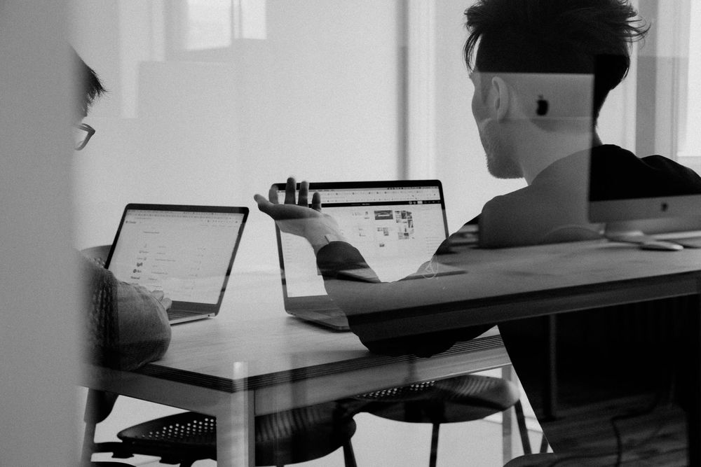 Two guys working with computers