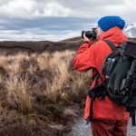 A photographer with camera shooting the nature