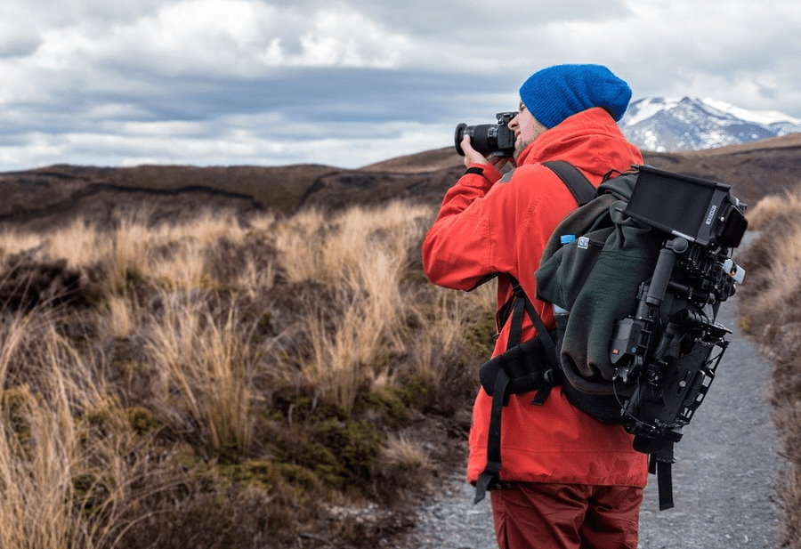 A photographer with camera shooting the nature