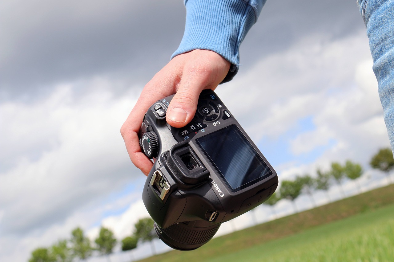 Photo camera hand holding