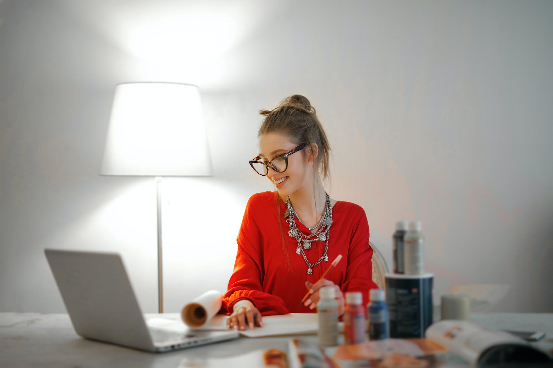 A girl writing and reading the computer