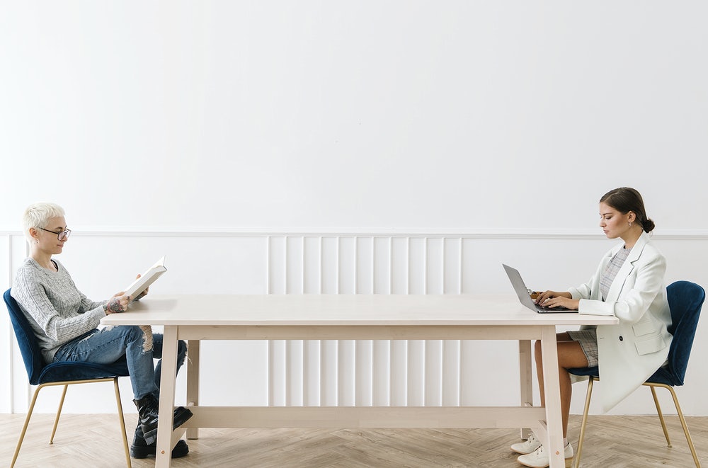 Two womens reading and working