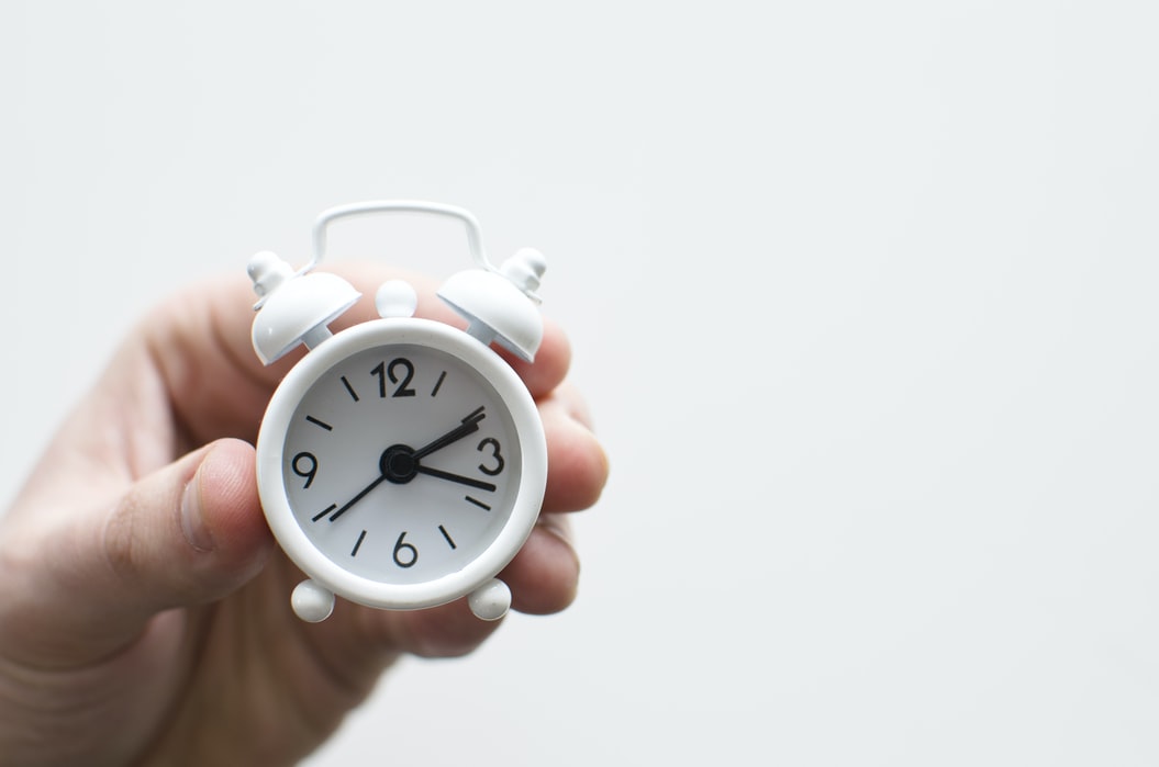 A hand holding clock