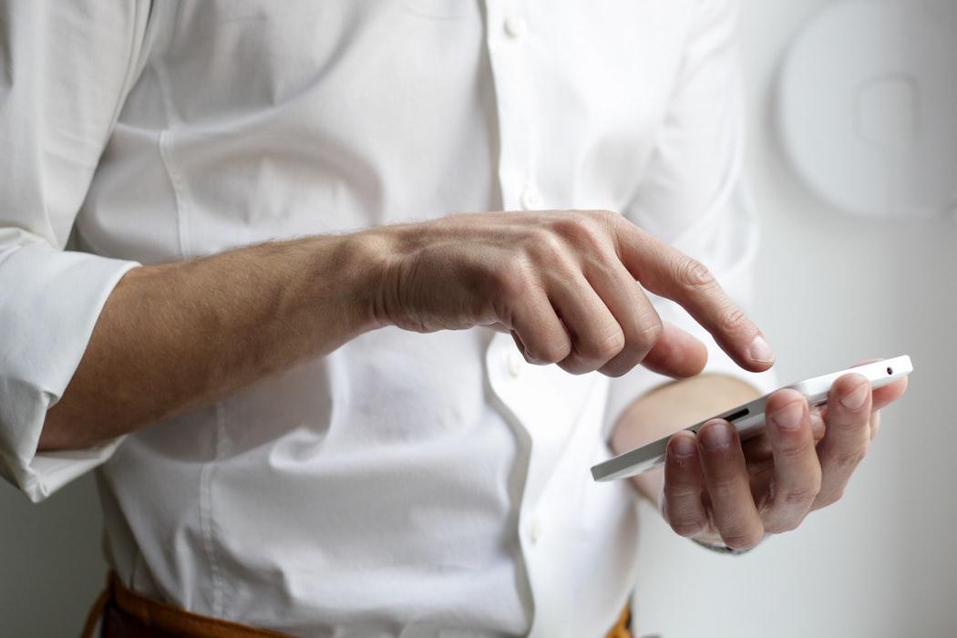 A man typing in phone