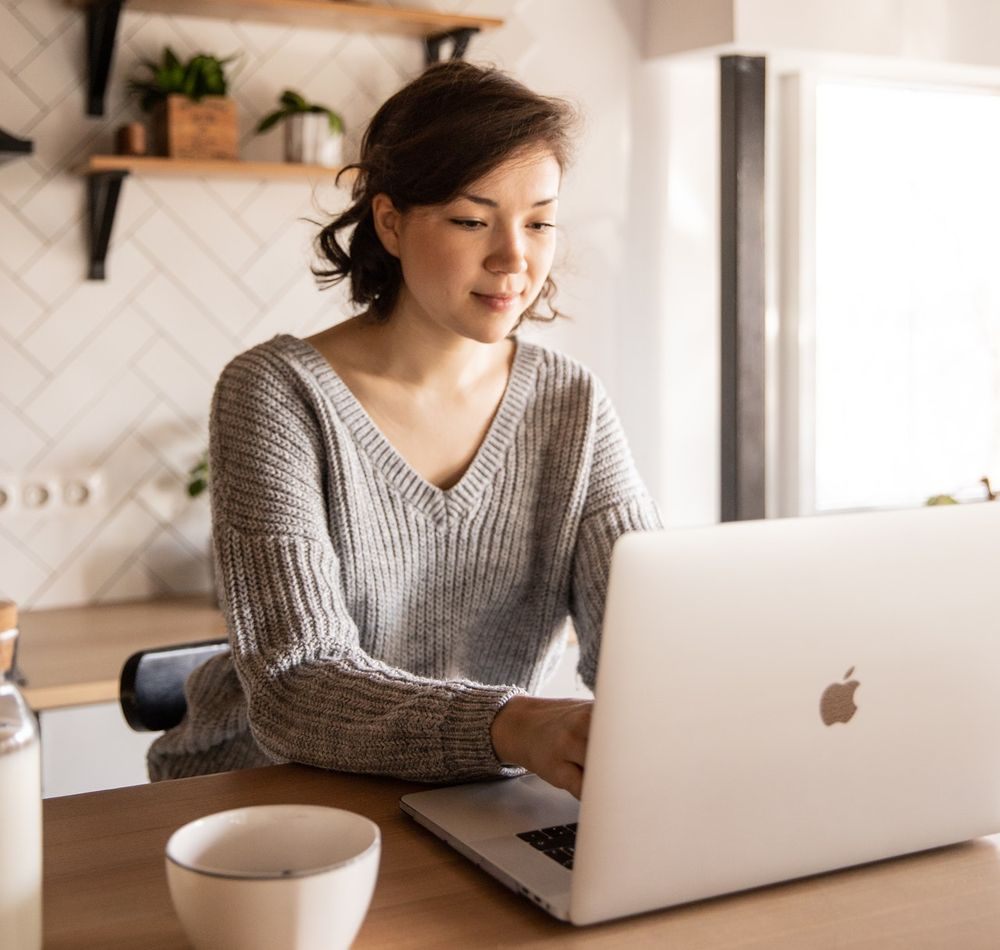 A women working with computer in kitchen