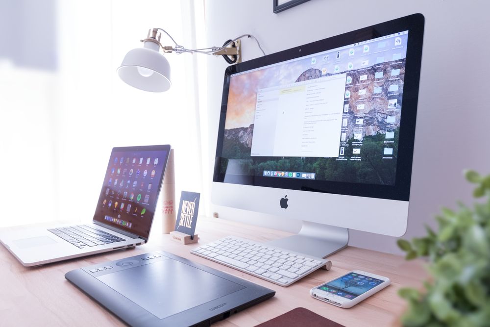 A macbook and imac on the desk