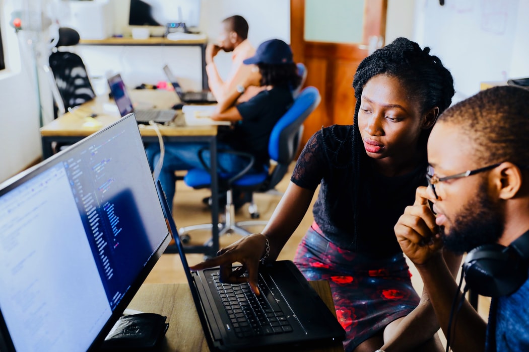 A women and man learning by computer