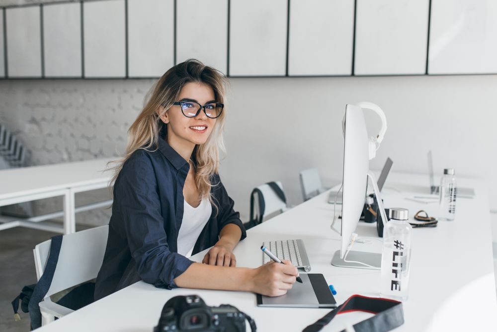 A women sitting by desk