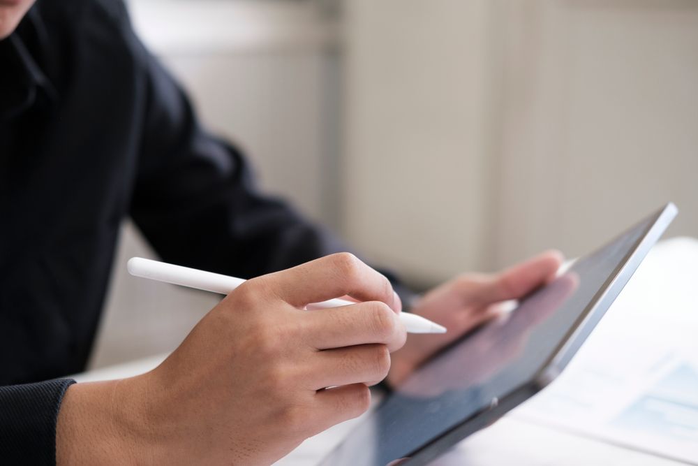 A man using digital signature in ipad