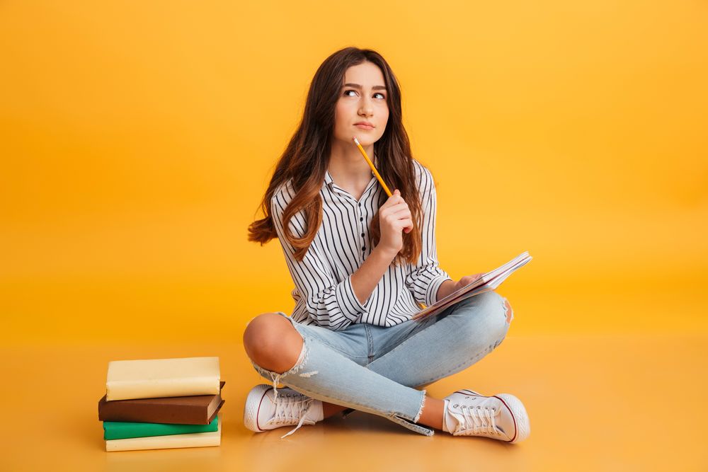 A girl thinking and writing