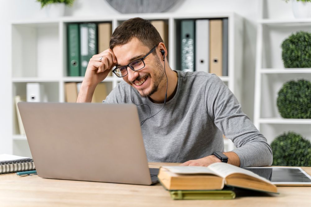 A man reading computer and books