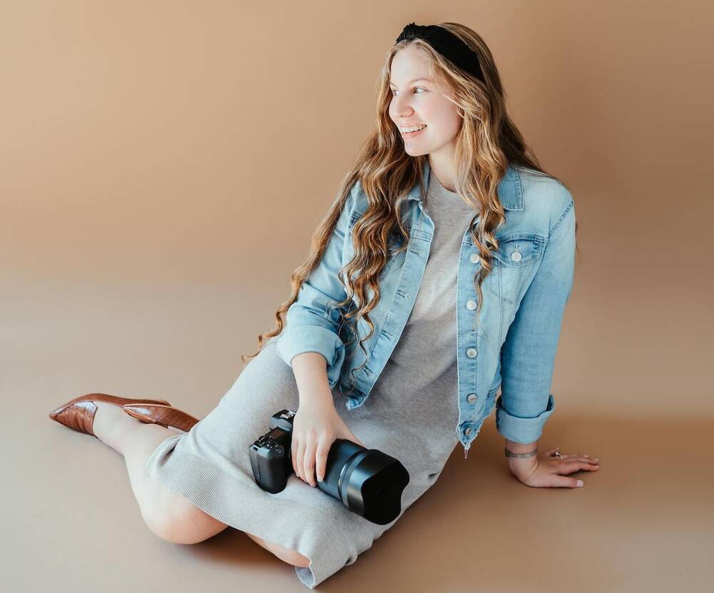 A beautiful woman with a camera in hands