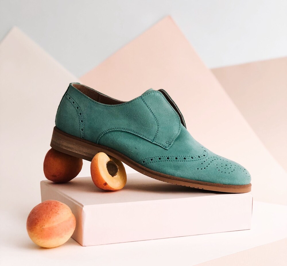 A green shoe with peach photography